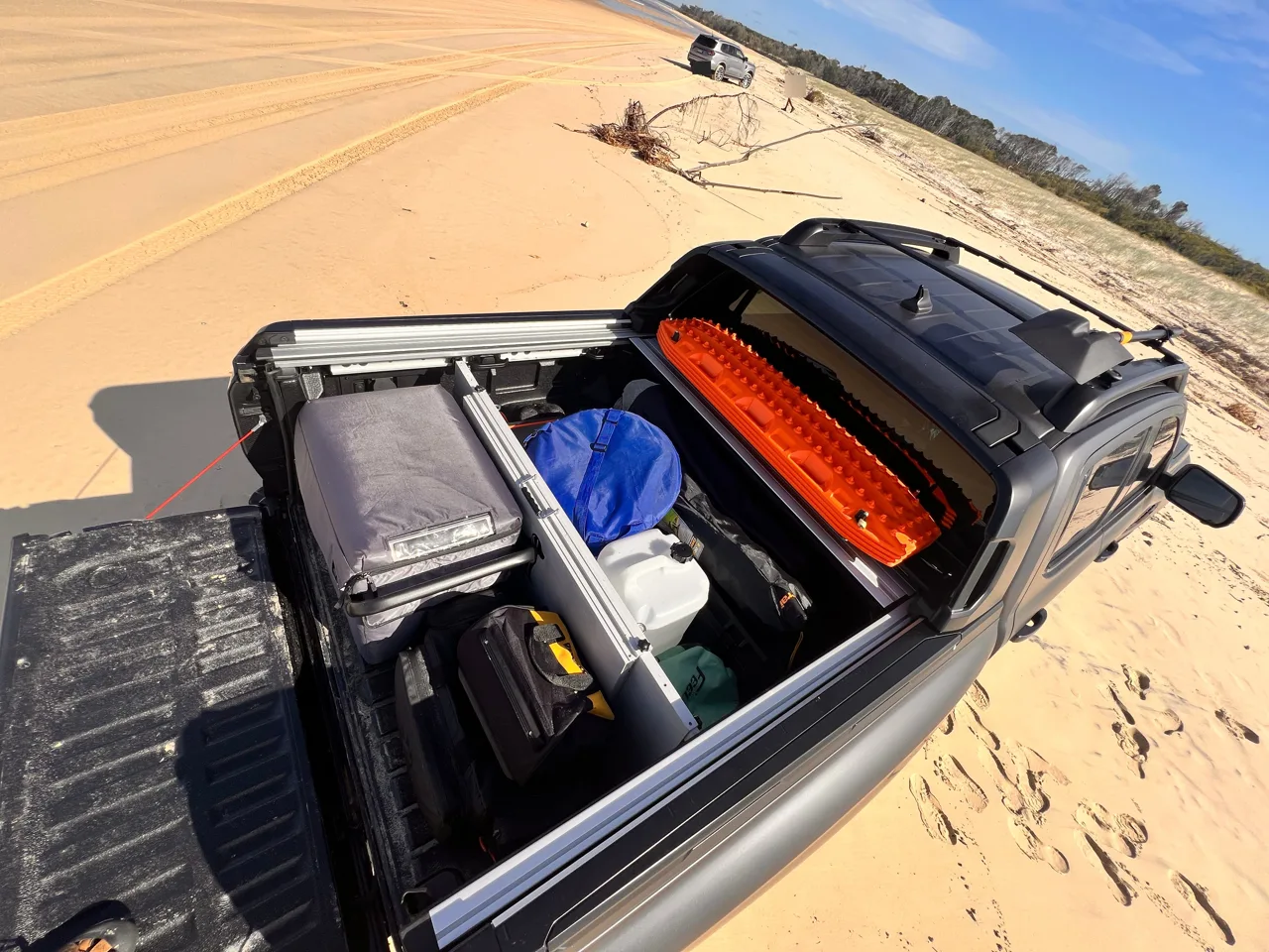 Prototype divider separating a fridge and cargo on a sand-island trip